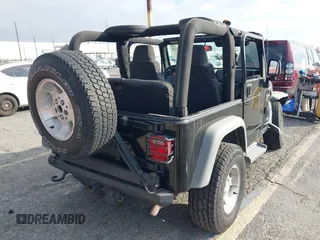 2003 Jeep Wrangler Sport with VIN 1J4FA49S23P328867, listed as a IAAI auction lot 41354414 with 96,703 mi miles. Bid and sale history available at carsss.com. Image 4.