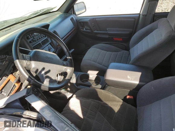 1997 Jeep Grand Cherokee Laredo with VIN 1J4GZ58S5VC561060, listed as a Copart auction lot 52098315 with 267,245 mi miles and Salvage title. Bid and sale history available at DreamBid. Image 7.
