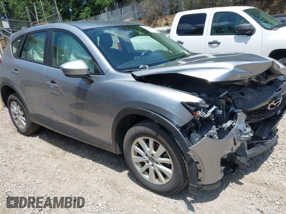 2014 Mazda CX-5 Sport with VIN JM3KE2BEXE0329303, listed as a IAAI auction lot 42556908 with 127,836 mi miles and . Bid and sale history available at DreamBid. Image 1.