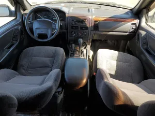 1999 Jeep Grand Cherokee Laredo with VIN 1J4GW58N4XC739465, listed as a Copart auction lot 76130544 with 195,649 mi miles and Salvage title. Bid and sale history available at DreamBid. Image 8.