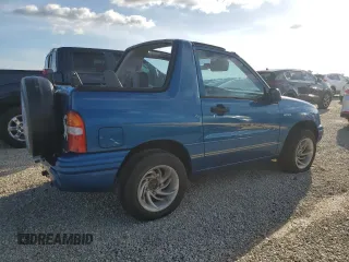 2001 Suzuki Vitara JLS z VIN 2S3TC52C116101163, wystawiony jako Copart lot #74469744 z przebiegiem Nie podano mil oraz Szkody całkowita. Historia ofert i sprzedaży dostępna na DreamBid. Obrazek 3.