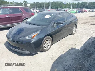 2021 Toyota Prius L Eco z VIN JTDKAMFU6M3141392, wystawiony jako IAAI lot #42317866 z przebiegiem 137 495 mil mil oraz . Historia ofert i sprzedaży dostępna na DreamBid. Obrazek 2.