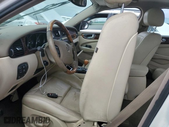 2004 Jaguar XJ with VIN SAJWA71C44SG34094, listed as a Copart auction lot 74969004 with 0 mi miles and Salvage Title. Bid and sale history available at carsss.com. Image 7.
