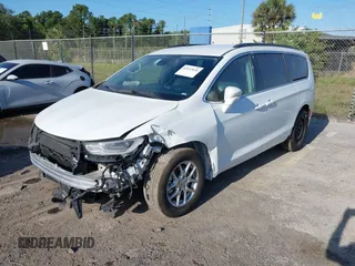 2022 Chrysler Pacifica Touring L with VIN 2C4RC1BGXNR233654, listed as a IAAI auction lot 42137632 with 73,899 mi miles and . Bid and sale history available at DreamBid. Image 2.