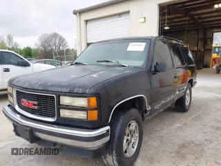 1996 GMC Yukon with VIN 1GKEK13R0TJ739663, listed as a IAAI auction lot 41942883 with 411,219 mi miles. Bid and sale history available at carsss.com. Image 6.