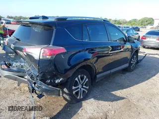 2018 Toyota RAV4 LE with VIN JTMZFREV1JJ203943, listed as a IAAI auction lot 41921863 with 104,691 mi miles. Bid and sale history available at carsss.com. Image 4.