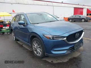 2019 Mazda CX-5 Grand Touring with VIN JM3KFBDM2K0580930, listed as a IAAI auction lot 42283845 with 80,310 mi miles and . Bid and sale history available at DreamBid. Image 1.