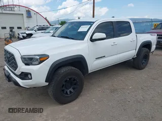 2022 Toyota Tacoma SR with VIN 3TMCZ5AN1NM478457, listed as a IAAI auction lot 42479107 with 59,547 mi miles and . Bid and sale history available at DreamBid. Image 2.