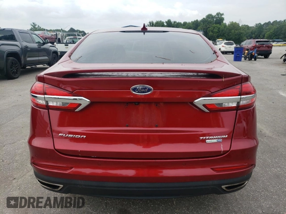 2019 Ford Fusion Titanium z VIN 3FA6P0D99KR221328, wystawiony jako Copart lot #57104515 z przebiegiem 138 427 mil mil oraz Szkoda całkowita • Salvage title. Historia ofert i sprzedaży dostępna na DreamBid. Obrazek 6.