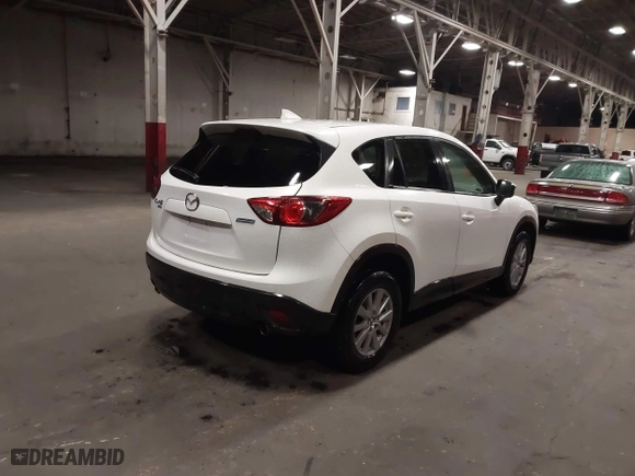 2016 Mazda CX-5 Touring with VIN JM3KE4CY0G0853261, listed as a IAAI auction lot 41861176 with 63,491 mi miles. Bid and sale history available at carsss.com. Image 4.