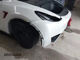 2023 Tesla Model Y Long Range with VIN 7SAYGDEE7PA100523, listed as a IAAI auction lot 40399455 with 18,885 mi miles and . Bid and sale history available at DreamBid. Image 6.