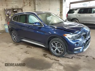 2019 BMW X1 xDrive28i with VIN WBXHT3C55K5L37338, listed as a IAAI auction lot 41934461 with 87,913 mi miles. Bid and sale history available at carsss.com. Image 1.