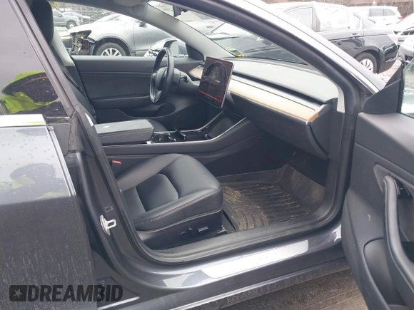 2019 Tesla Model 3 Mid Range with VIN 5YJ3E1EA3KF307415, listed as a IAAI auction lot 41673239 with 42,895 mi miles and . Bid and sale history available at DreamBid. Image 5.
