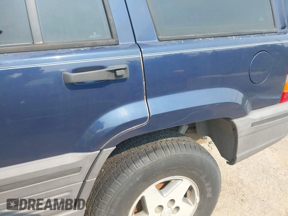 1994 Jeep Grand Cherokee Laredo z VIN 1J4GZ58Y7RC233746, wystawiony jako IAAI lot #42722206 z przebiegiem 196 875 mil mil oraz . Historia ofert i sprzedaży dostępna na DreamBid. Obrazek 6.