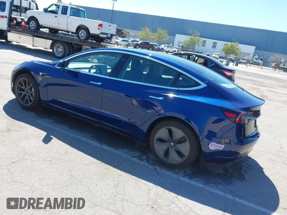 2019 Tesla Model 3 Mid Range with VIN 5YJ3E1EA0KF425079, listed as a IAAI auction lot 41871022 with 61,684 mi miles and . Bid and sale history available at DreamBid. Image 3.