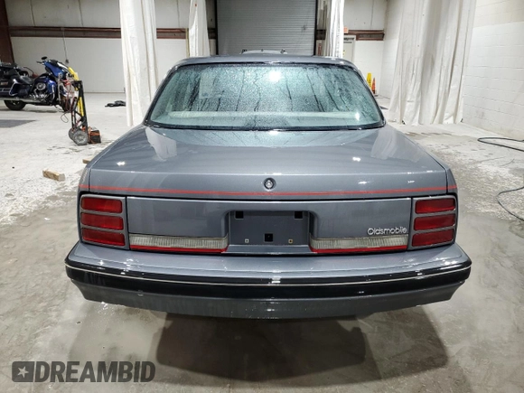 1991 Oldsmobile Cutlass Ciera with VIN 2G3AM54N8M2304905, listed as a Copart auction lot 52047535 with 28,749 mi miles and Salvage Title. Bid and sale history available at DreamBid. Image 6.
