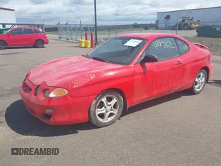 2001 Hyundai Tiburon z VIN KMHJG25F71U226180, wystawiony jako IAAI lot #42123872 z przebiegiem 167 444 mil mil oraz . Historia ofert i sprzedaży dostępna na DreamBid. Obrazek 2.