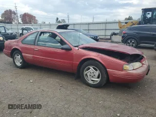 1996 Ford Thunderbird LX with VIN 1FALP62W7TH135632, listed as a Copart auction lot 77134024 with 128,931 mi miles and Salvage Title. Bid and sale history available at DreamBid. Image 4.