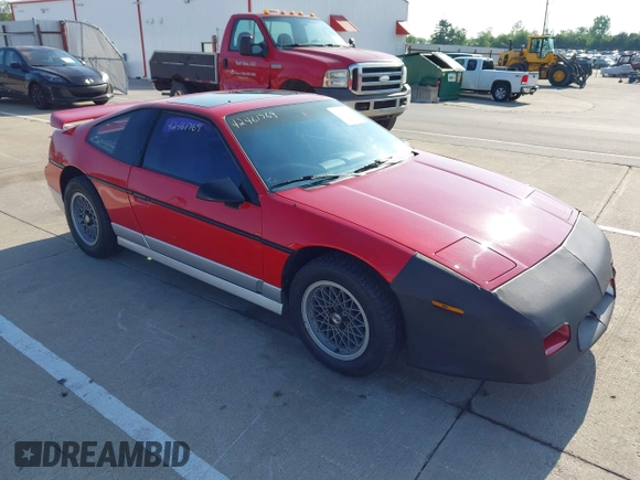 1986 Pontiac Fiero z VIN 1G2PG9791GP267415, wystawiony jako IAAI lot #42461769 z przebiegiem Nie podano mil oraz . Historia ofert i sprzedaży dostępna na DreamBid. Obrazek 1.