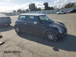 2004 MINI Hardtop with VIN WMWRC33464TJ62893, listed as a Copart auction lot 51905565 with 141,958 mi miles and Salvage Title. Bid and sale history available at DreamBid. Image 4.