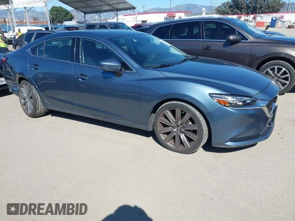 2018 Mazda 6 Grand Touring with VIN JM1GL1TY4J1333021, listed as a IAAI auction lot 41818719 with 56,188 mi miles and . Bid and sale history available at DreamBid. Image 1.