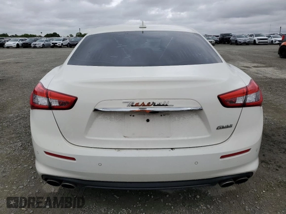2018 Maserati Ghibli z VIN ZAM57XSA9J1271727, wystawiony jako Copart lot #52155305 z przebiegiem 62 081 mil mil oraz Szkoda całkowita • Salvage title. Historia ofert i sprzedaży dostępna na DreamBid. Obrazek 6.