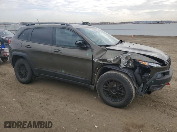 2015 Jeep Cherokee Trailhawk with VIN 1C4PJMBS0FW678738, listed as a Copart auction lot 50651235 with 147,793 mi miles and Salvage title. Bid and sale history available at DreamBid. Image 4.