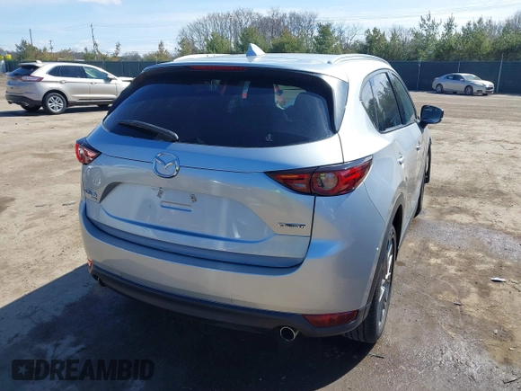 2021 Mazda CX-5 Grand Touring with VIN JM3KFBDM3M1300316, listed as a IAAI auction lot 41878520 with 77,670 mi miles and . Bid and sale history available at DreamBid. Image 4.