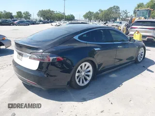 2014 Tesla Model S P85D with VIN 5YJSA1H25EFP65571, listed as a IAAI auction lot 42185442 with 115,990 mi miles and . Bid and sale history available at DreamBid. Image 4.