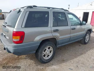 1999 Jeep Grand Cherokee Laredo with VIN 1J4GW58S6XC613307, listed as a IAAI auction lot 41592687 with 264,176 mi miles. Bid and sale history available at carsss.com. Image 4.