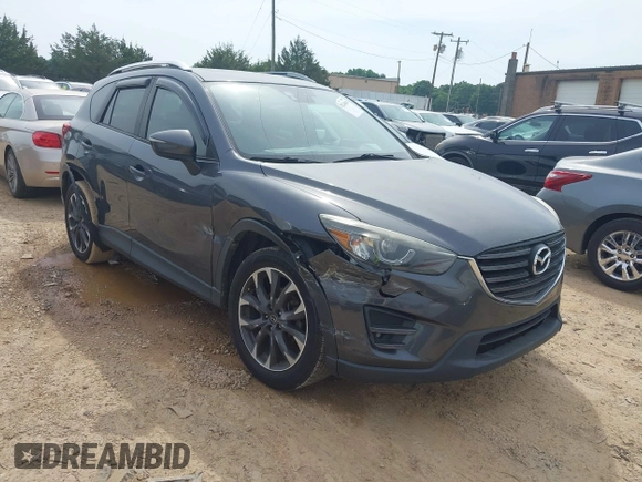2016 Mazda CX-5 Grand Touring z VIN JM3KE2DY5G0801238, wystawiony jako IAAI lot #42264694 z przebiegiem 136 993 mil mil oraz . Historia ofert i sprzedaży dostępna na DreamBid. Obrazek 1.