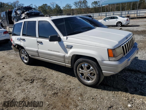 1996 Jeep Grand Cherokee Laredo with VIN 1J4FX58SXTC349575, listed as a Copart auction lot 80545584 with 302,636 mi miles and Salvage Title. Bid and sale history available at carsss.com. Image 4.