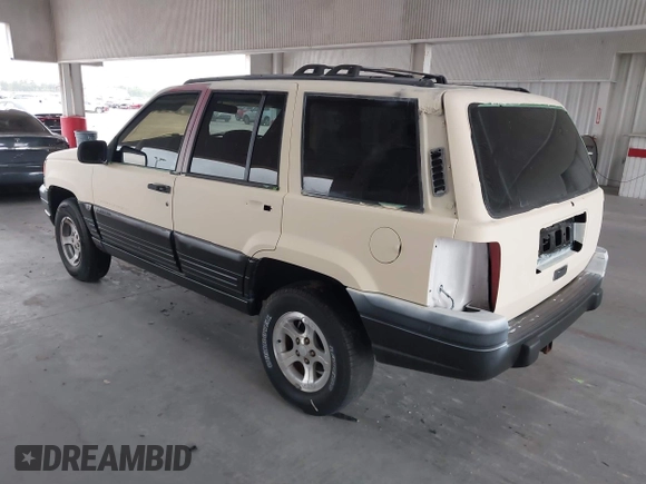 1996 Jeep Grand Cherokee Laredo z VIN 1J4FX58S7TC157272, wystawiony jako IAAI lot #42422023 z przebiegiem 229 170 mil mil oraz . Historia ofert i sprzedaży dostępna na DreamBid. Obrazek 3.