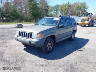 1997 Jeep Grand Cherokee Laredo with VIN 1J4GZ58S7VC713517, listed as a IAAI auction lot 42062214 with 205,533 mi miles. Bid and sale history available at carsss.com. Image 2.