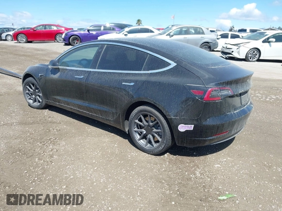 2019 Tesla Model 3 Mid Range with VIN 5YJ3E1EA3KF325056, listed as a IAAI auction lot 41771543 with 183,157 mi miles and . Bid and sale history available at carsss.com. Image 3.
