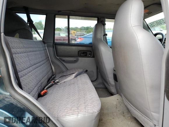1998 Jeep Cherokee Sport z VIN 1J4FJ68S4WL101110, wystawiony jako Copart lot #57696755 z przebiegiem 218 254 mil mil oraz Szkoda całkowita • Salvage title. Historia ofert i sprzedaży dostępna na DreamBid. Obrazek 11.