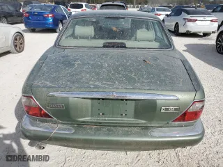 1999 Jaguar XJ with VIN SAJHD1043XC869413, listed as a Copart auction lot 76940624 with 0 mi miles and Salvage Title. Bid and sale history available at carsss.com. Image 6.