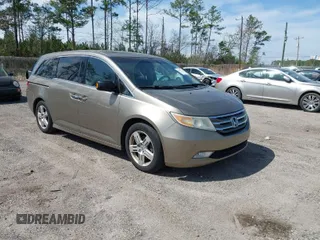 2011 Honda Odyssey Touring with VIN 5FNRL5H93BB077934, listed as a IAAI auction lot 41807514 with 215,685 mi miles and . Bid and sale history available at DreamBid. Image 1.