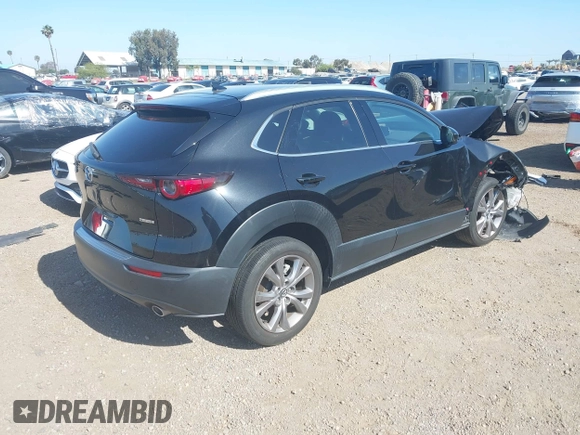 2022 Mazda CX-30 S Premium with VIN 3MVDMBDL6NM407913, listed as a IAAI auction lot 42359860 with 35,804 mi miles and . Bid and sale history available at DreamBid. Image 4.
