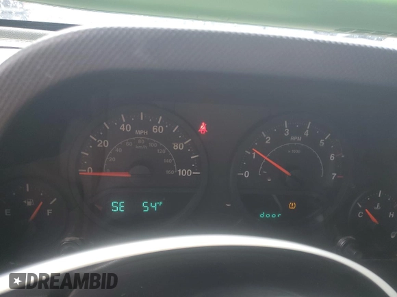 2009 Jeep Wrangler X with VIN 1J4FA24179L700884, listed as a Copart auction lot 52194055 with 96,189 mi miles and Salvage Title. Bid and sale history available at DreamBid. Image 9.