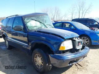 1999 GMC Jimmy SLE with VIN 1GKDT13W3X2553792, listed as a IAAI auction lot 41876489 with 266,884 mi miles. Bid and sale history available at carsss.com. Image 1.