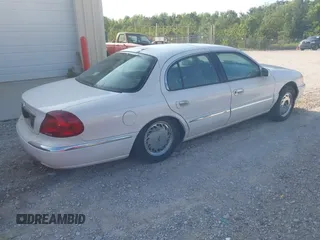 1998 Lincoln Continental z VIN 1LNLM97V1WY602564, wystawiony jako IAAI lot #42333637 z przebiegiem 142 234 mil mil oraz . Historia ofert i sprzedaży dostępna na DreamBid. Obrazek 4.