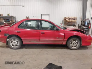 1999 Pontiac Sunfire SE z VIN 1G2JB524XX7547651, wystawiony jako IAAI lot #41962158 z przebiegiem 130 385 mil mil oraz . Historia ofert i sprzedaży dostępna na DreamBid. Obrazek 13.