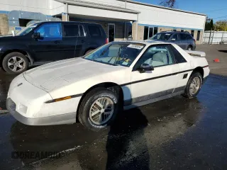 1985 Pontiac Fiero z VIN 1G2PG3796FP269589, wystawiony jako Copart lot #73338954 z przebiegiem 34 364 mil mil oraz Tytuł czysty. Historia ofert i sprzedaży dostępna na DreamBid. Obrazek 1.
