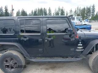 2014 Jeep Wrangler Unlimited Sahara with VIN 1C4BJWEG6EL107526, listed as a IAAI auction lot 42030244 with 69,077 mi miles. Bid and sale history available at carsss.com. Image 13.