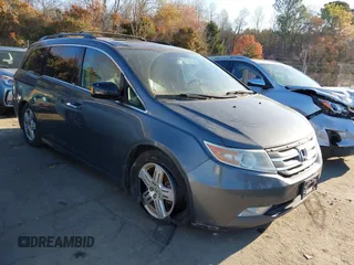 2013 Honda Odyssey Touring with VIN 5FNRL5H9XDB009973, listed as a IAAI auction lot 41904710 with 219,067 mi miles and . Bid and sale history available at carsss.com. Image 1.