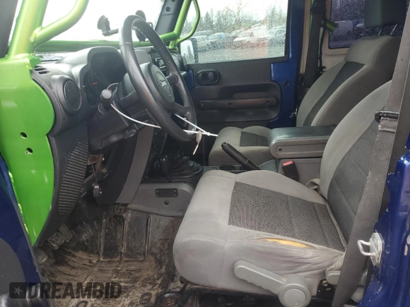 2009 Jeep Wrangler X with VIN 1J4FA24179L700884, listed as a Copart auction lot 52194055 with 96,189 mi miles and Salvage Title. Bid and sale history available at DreamBid. Image 7.
