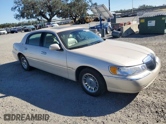 2001 Lincoln Town Car Cartier z VIN 1LNHM83W31Y671814, wystawiony jako Copart lot #77169664 z przebiegiem Nie podano mil oraz Szkoda całkowita • Salvage title. Historia ofert i sprzedaży dostępna na DreamBid. Obrazek 4.