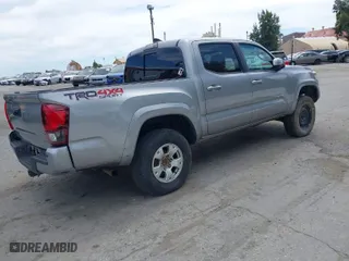 2019 Toyota Tacoma 4WD SR with VIN 3TMCZ5AN4KM194526, listed as a IAAI auction lot 42021504 with 87,767 mi miles. Bid and sale history available at carsss.com. Image 4.