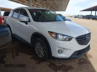 2016 Mazda CX-5 Touring z VIN JM3KE4CY9G0750386, wystawiony jako IAAI lot #42361456 z przebiegiem 40 465 mil mil oraz . Historia ofert i sprzedaży dostępna na DreamBid. Obrazek 1.